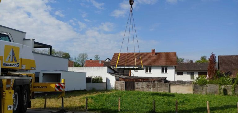 Konstruktion einer Poolabdeckung: Kran hebt Boden auf den Pool